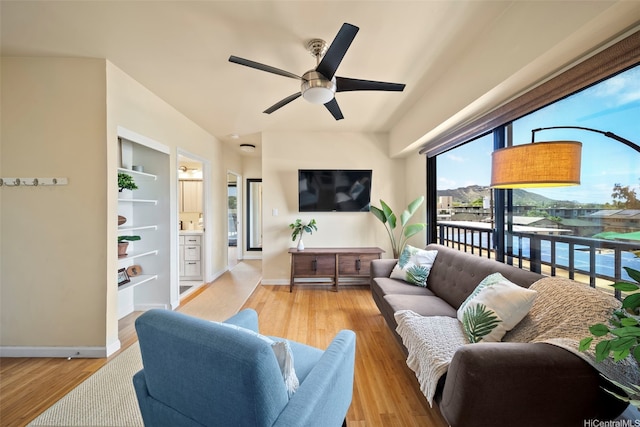 738 Palani Ave Unit 401, Honolulu, HI 96816 - living room with light wood finished floors, a ceiling fan, baseboards, and built in features