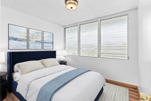 94-249 Waikele Rd Unit A304, Waipahu, HI 96797 - bedroom featuring wood finished floors and a textured ceiling