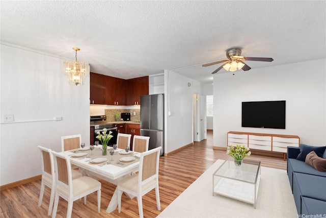 94-249 Waikele Rd Unit A304, Waipahu, HI 96797 - dining space with light wood finished floors, ceiling fan, baseboards, a chandelier, and a textured ceiling