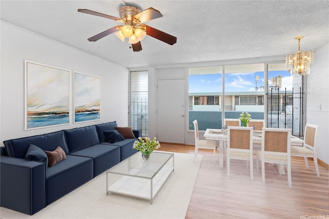 94-249 Waikele Rd Unit A304, Waipahu, HI 96797 - living room featuring wood finished floors, a chandelier, ceiling fan, and a textured ceiling