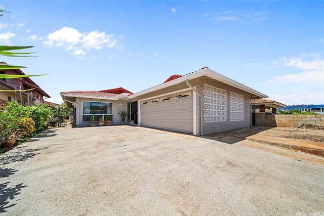 94-860 Kuhaulua St, Waipahu, HI 96797 - ranch-style home featuring a tiled roof, an attached garage, driveway, and stucco siding