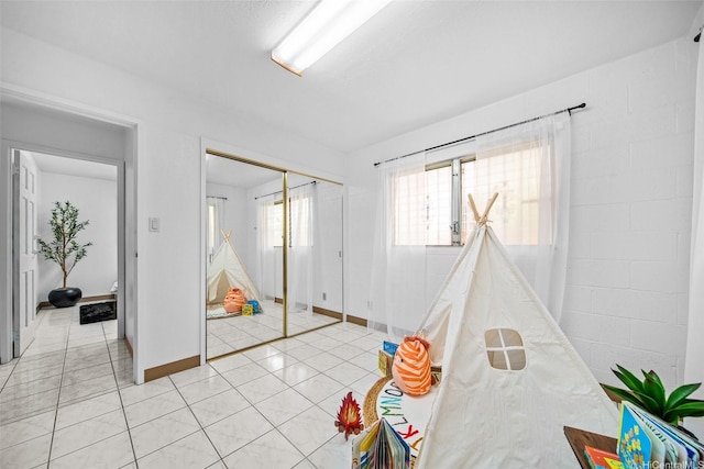 94-860 Kuhaulua St, Waipahu, HI 96797 - recreation room featuring light tile patterned floors and baseboards