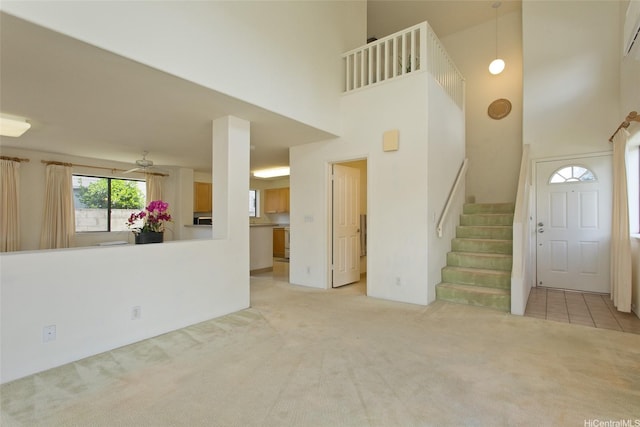 94-1014 Makakoa Loop, Waipahu, HI 96797 - unfurnished living room featuring carpet flooring, a towering ceiling, and stairway