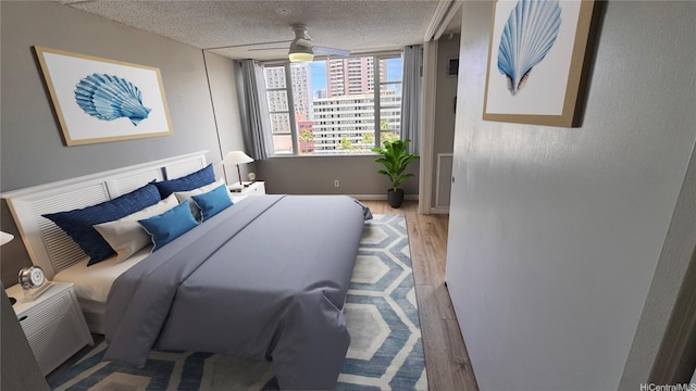 400 Hobron Ln Unit 1109, Honolulu, HI 96815 - bedroom featuring wood finished floors, a textured ceiling, and baseboards