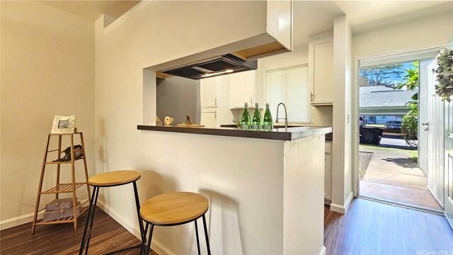 95-786 Wikao St Unit M103, Mililani, HI 96789 - bar area featuring dark wood-style flooring and baseboards