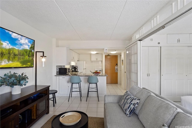 1777 Ala Moana Blvd Unit 1517, Honolulu, HI 96815 - living area featuring light tile patterned floors and a textured ceiling