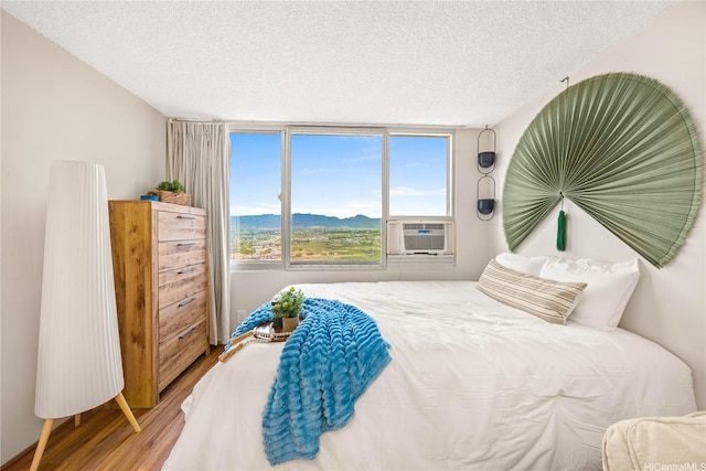 1060 Kamehameha Hwy Unit 2901A, Pearl City, HI 96782 - bedroom featuring wood finished floors, a textured ceiling, cooling unit, and a mountain view