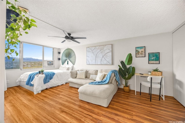 1060 Kamehameha Hwy Unit 2901A, Pearl City, HI 96782 - bedroom featuring a textured ceiling, wood finished floors, a ceiling fan, and a mountain view