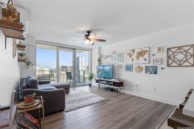 629 Keeaumoku St Unit 2505, Honolulu, HI 96814 - living room with ceiling fan, wood finished floors, a wall of windows, and baseboards