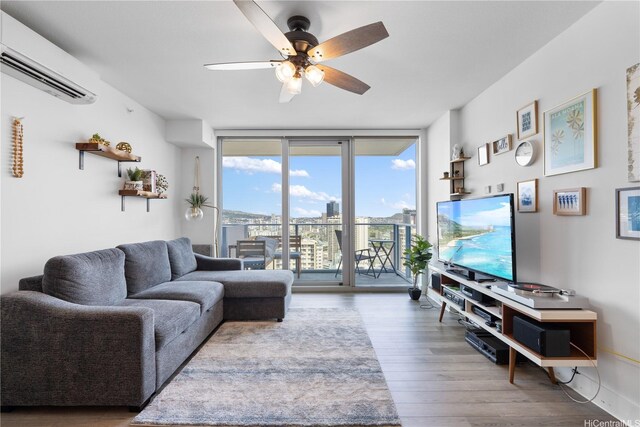 629 Keeaumoku St Unit 2505, Honolulu, HI 96814 - living room with floor to ceiling windows, a wall unit AC, ceiling fan, and wood finished floors