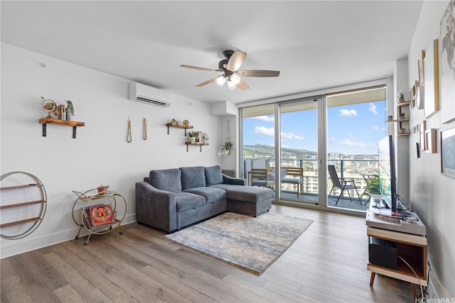 629 Keeaumoku St Unit 2505, Honolulu, HI 96814 - living room featuring a wall mounted AC, floor to ceiling windows, ceiling fan, and wood finished floors