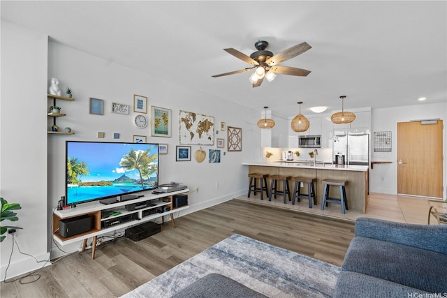 629 Keeaumoku St Unit 2505, Honolulu, HI 96814 - living room featuring ceiling fan, light wood finished floors, baseboards, and recessed lighting