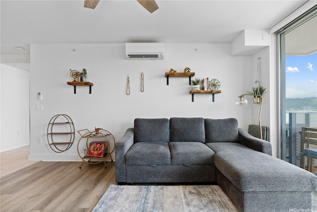 629 Keeaumoku St Unit 2505, Honolulu, HI 96814 - living area with a wall mounted AC, wood finished floors, baseboards, and a ceiling fan