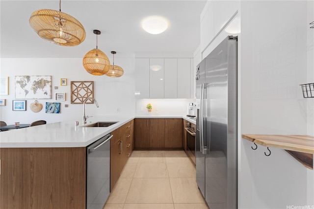 629 Keeaumoku St Unit 2505, Honolulu, HI 96814 - kitchen featuring appliances with stainless steel finishes, a sink, a peninsula, white cabinets, and modern cabinets