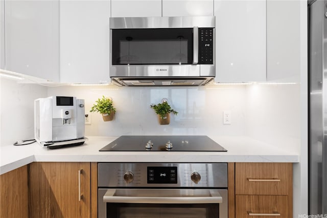 629 Keeaumoku St Unit 2505, Honolulu, HI 96814 - kitchen with appliances with stainless steel finishes, brown cabinetry, decorative backsplash, and modern cabinets