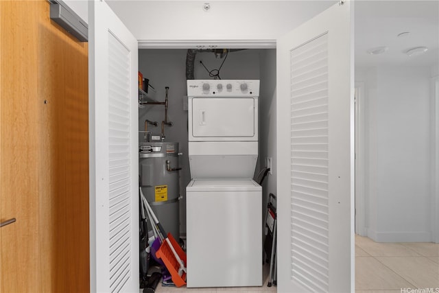 629 Keeaumoku St Unit 2505, Honolulu, HI 96814 - laundry room with stacked washer / drying machine, secured water heater, and light tile patterned floors