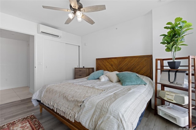 629 Keeaumoku St Unit 2505, Honolulu, HI 96814 - bedroom featuring a wall mounted AC, wood finished floors, a closet, and ceiling fan