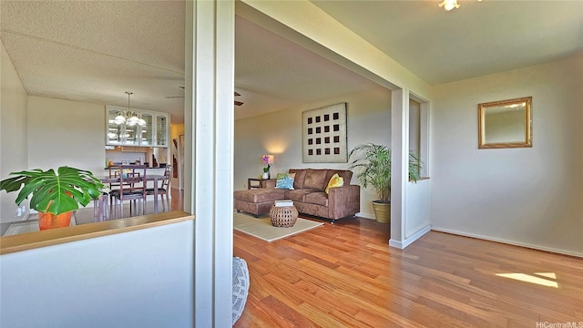 98-1451 Kaahumanu St Unit B218, Aiea, HI 96701 - living room featuring wood finished floors and a chandelier
