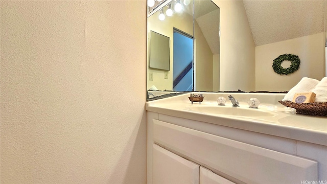 98-1451 Kaahumanu St Unit B218, Aiea, HI 96701 - bathroom featuring vanity, vaulted ceiling, and a textured wall