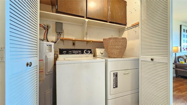 98-1451 Kaahumanu St Unit B218, Aiea, HI 96701 - laundry room featuring cabinet space, electric water heater, wood finished floors, and washer and clothes dryer