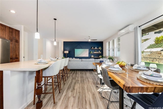 84-814 Maiola St Unit 39, Waianae, HI 96792 - dining space featuring an AC wall unit, light wood-type flooring, and ceiling fan