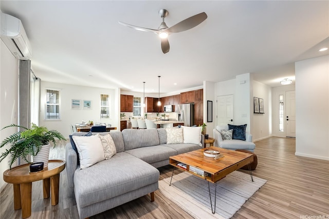 84-814 Maiola St Unit 39, Waianae, HI 96792 - living area featuring a ceiling fan, a wall unit AC, light wood-type flooring, and recessed lighting