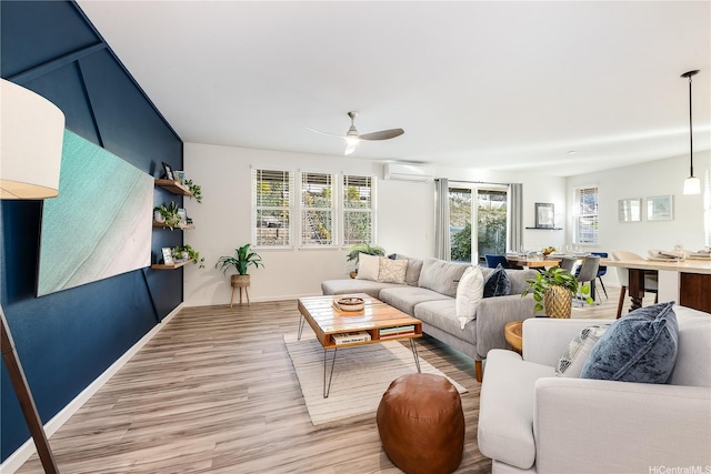 84-814 Maiola St Unit 39, Waianae, HI 96792 - living area with a wall mounted air conditioner, light wood-type flooring, and a ceiling fan
