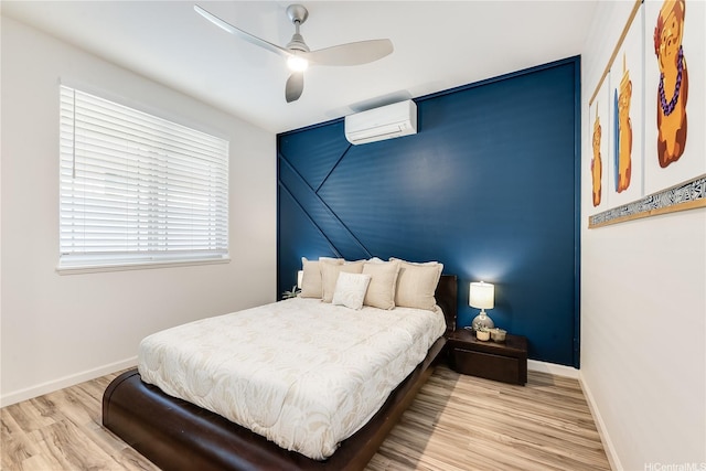 84-814 Maiola St Unit 39, Waianae, HI 96792 - bedroom featuring a wall mounted air conditioner, wood finished floors, baseboards, and ceiling fan