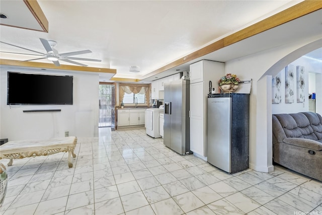 94-1090 Kuhaulua St, Waipahu, HI 96797 - kitchen featuring freestanding refrigerator, stainless steel refrigerator with ice dispenser, light marble finish floors, arched walkways, and white cabinetry