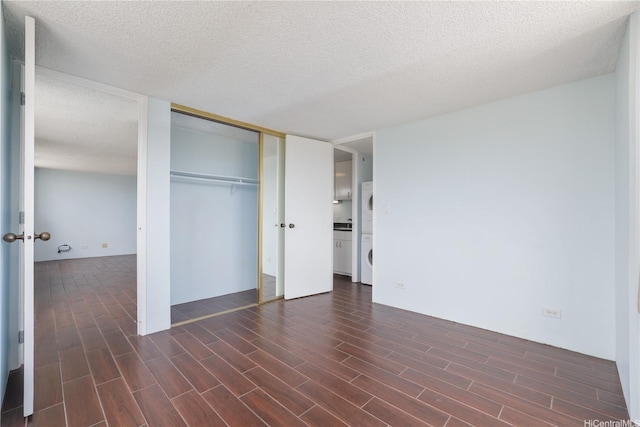 98-288 Kaonohi St Unit 1107, Aiea, HI 96701 - unfurnished bedroom with dark wood-style flooring, a textured ceiling, a closet, washer / clothes dryer, and french doors