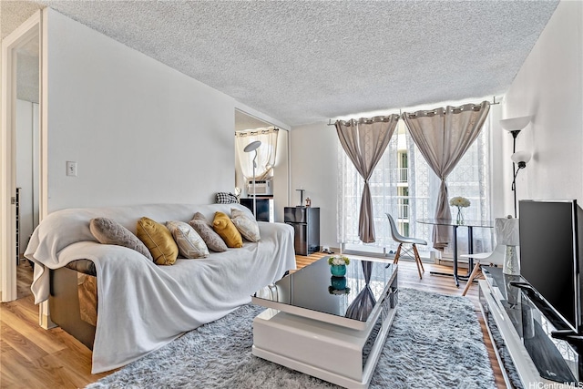 2452 Tusitala St Unit 705, Honolulu, HI 96815 - living area featuring a textured ceiling and wood finished floors