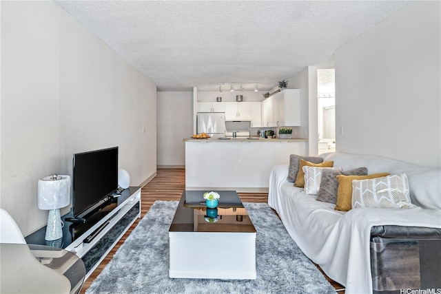 2452 Tusitala St Unit 705, Honolulu, HI 96815 - living area featuring a textured ceiling and wood finished floors