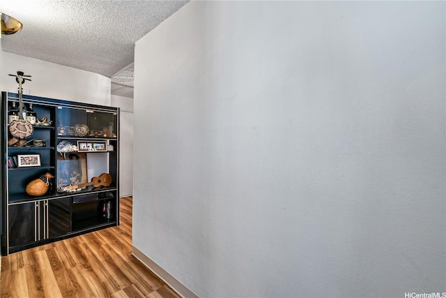 2452 Tusitala St Unit 705, Honolulu, HI 96815 - hall with a textured ceiling and wood finished floors