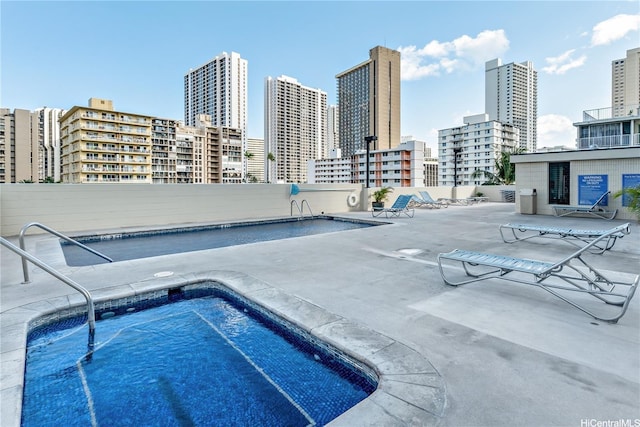 2452 Tusitala St Unit 705, Honolulu, HI 96815 - community pool featuring a skyline view and a patio area