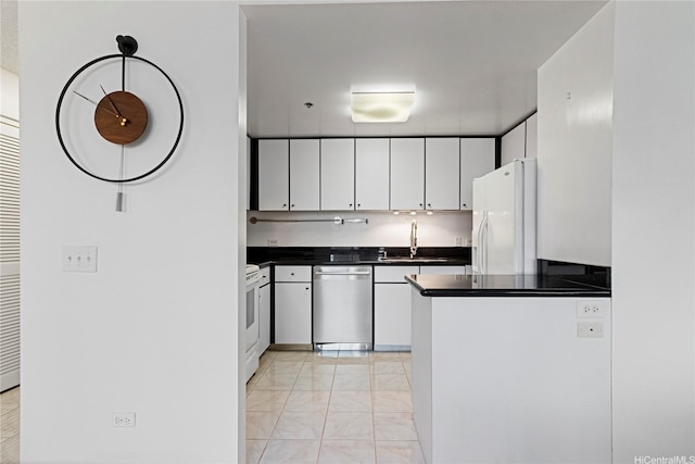 876 Curtis St Unit 1602, Honolulu, HI 96813 - kitchen featuring white appliances, a sink, dark countertops, white cabinets, and a peninsula
