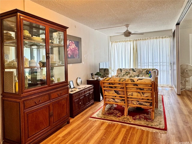 1655 Makaloa St Unit 705, Honolulu, HI 96814 - dining area featuring a textured ceiling, light wood-type flooring, and ceiling fan