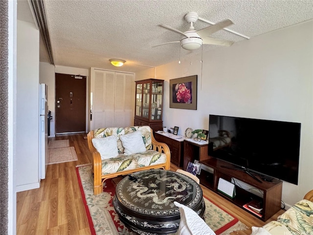 1655 Makaloa St Unit 705, Honolulu, HI 96814 - living room with a textured ceiling, ceiling fan, and wood finished floors