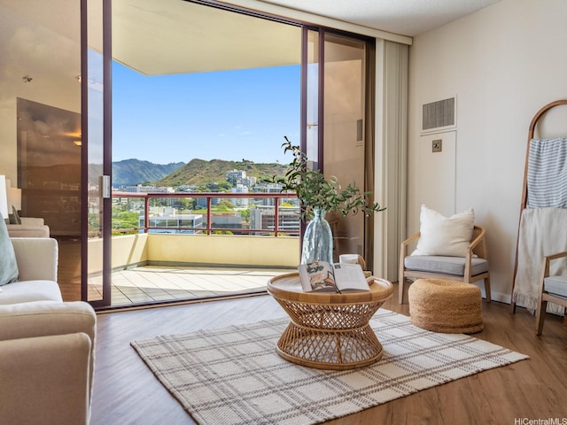 725 Kapiolani Blvd Unit 1105, Honolulu, HI 96813 - sitting room featuring a mountain view, wood finished floors, and expansive windows
