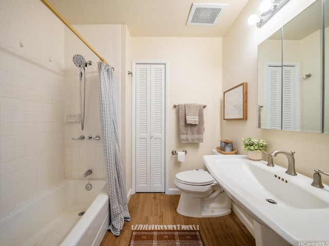 725 Kapiolani Blvd Unit 1105, Honolulu, HI 96813 - bathroom with a closet, wood finished floors, toilet, a sink, and shower / tub combo