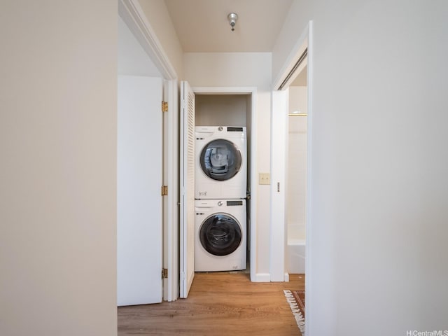 725 Kapiolani Blvd Unit 1105, Honolulu, HI 96813 - laundry room featuring stacked washer / dryer and light wood-style flooring