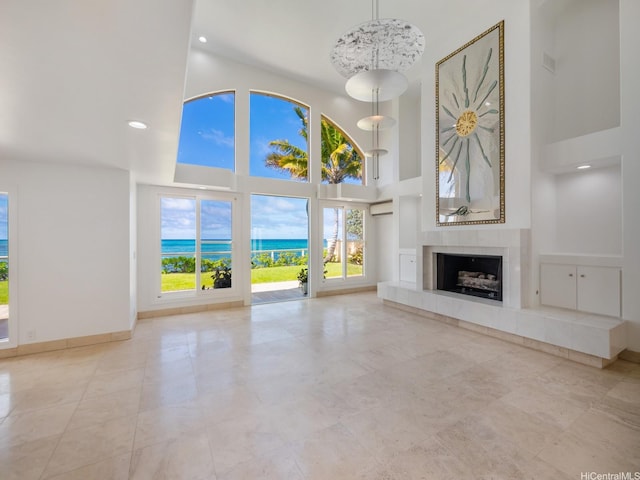 756 Mokulua Dr, Kailua, HI 96734 - unfurnished living room featuring a high ceiling, a tile fireplace, recessed lighting, and a water view