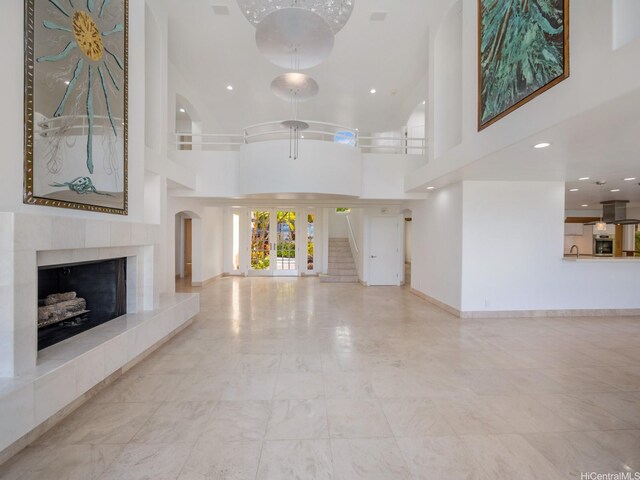 756 Mokulua Dr, Kailua, HI 96734 - unfurnished living room featuring a tile fireplace, recessed lighting, and a towering ceiling