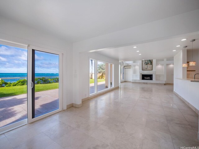 756 Mokulua Dr, Kailua, HI 96734 - unfurnished living room with a water view, a fireplace, recessed lighting, and light tile patterned floors