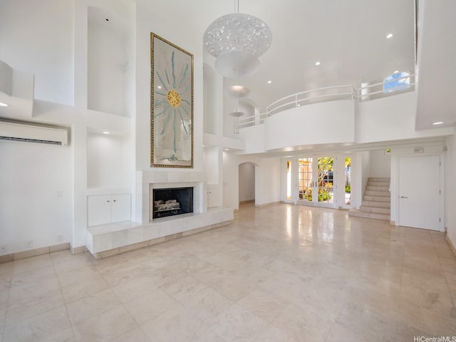 756 Mokulua Dr, Kailua, HI 96734 - unfurnished living room with a wall mounted AC, high vaulted ceiling, a fireplace, recessed lighting, and arched walkways