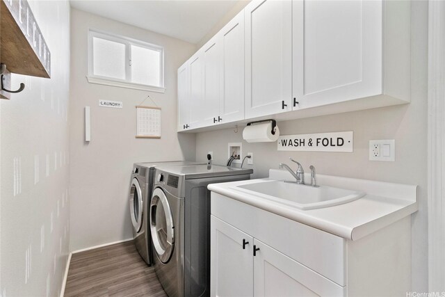 91-1123 Hokua St, Ewa Beach, HI 96706 - laundry room featuring cabinet space, washer and clothes dryer, wood finished floors, and baseboards