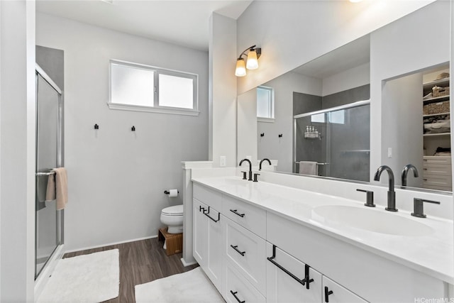 91-1123 Hokua St, Ewa Beach, HI 96706 - full bathroom with double vanity, a shower stall, wood finished floors, toilet, and baseboards