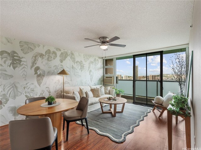 3009 Ala Makahala Pl Unit 1507, Honolulu, HI 96818 - living area with wood finished floors, a textured ceiling, a ceiling fan, and a wall of windows