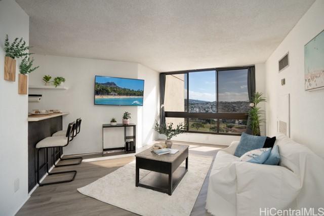 300 Wai Nani Way Unit 1815, Honolulu, HI 96815 - living room featuring floor to ceiling windows and wood finished floors