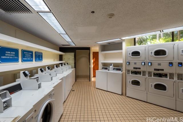 300 Wai Nani Way Unit 1815, Honolulu, HI 96815 - communal laundry room with washing machine and dryer, estacked washer and dryer, and light tile patterned floors