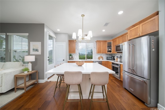 91-1124 Kai Oio St, Ewa Beach, HI 96706 - kitchen featuring appliances with stainless steel finishes, decorative backsplash, a chandelier, dark wood-type flooring, and recessed lighting